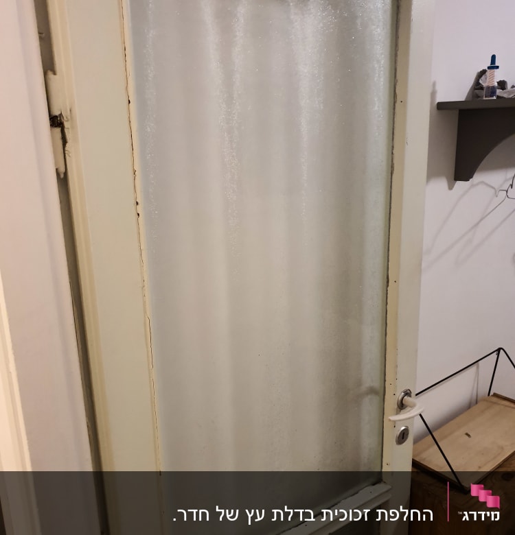 דלת עם זכוכית חלבית במסגרת עץ לבנה